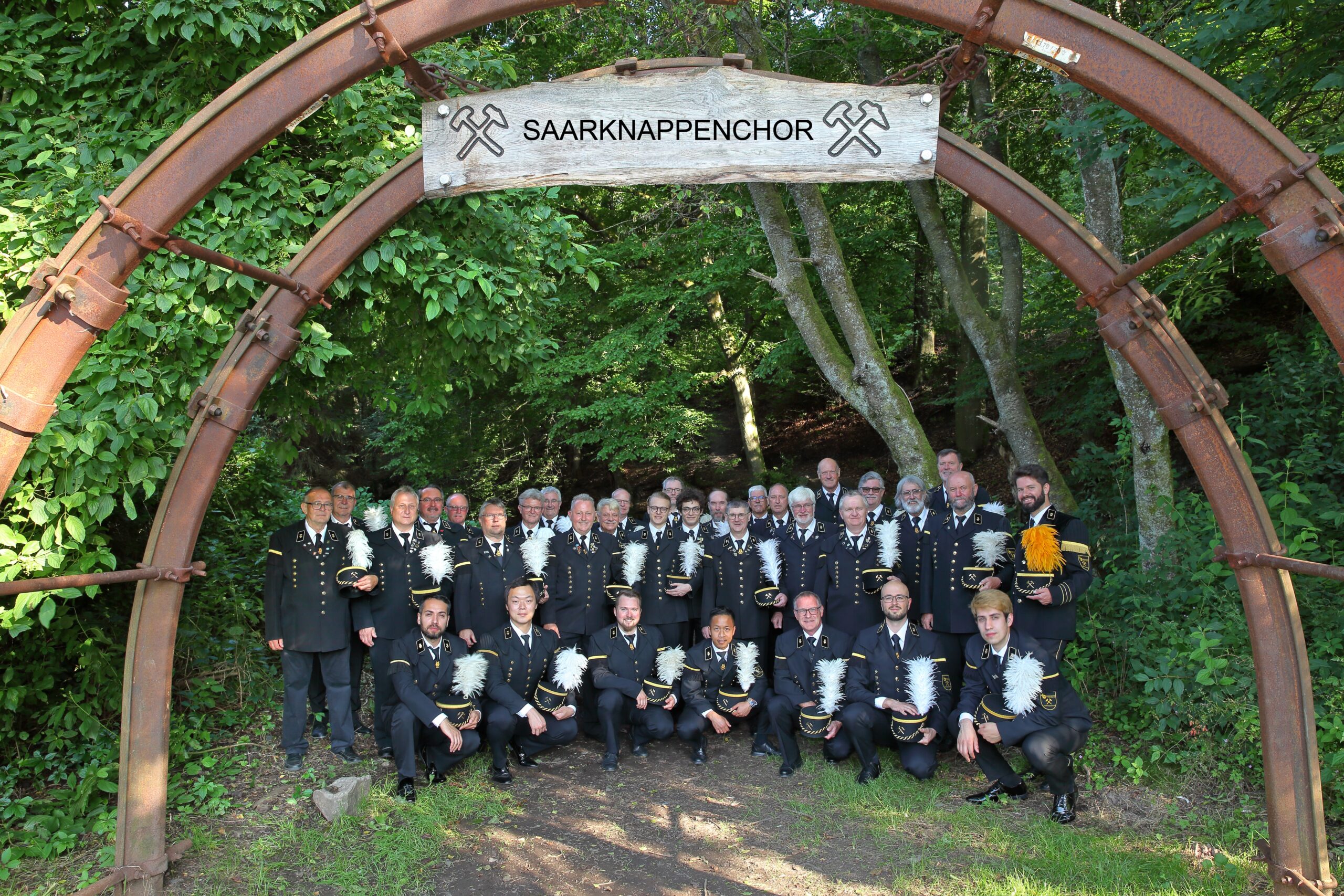 Der Saarknappenchor MGV Braunshausen steht unter einem hölzernen Bogen