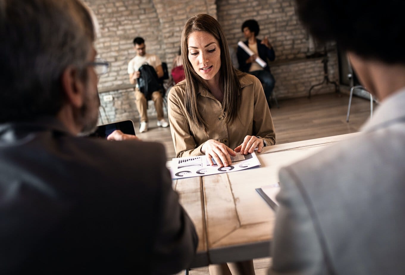 Woman talking with employer at job interview.