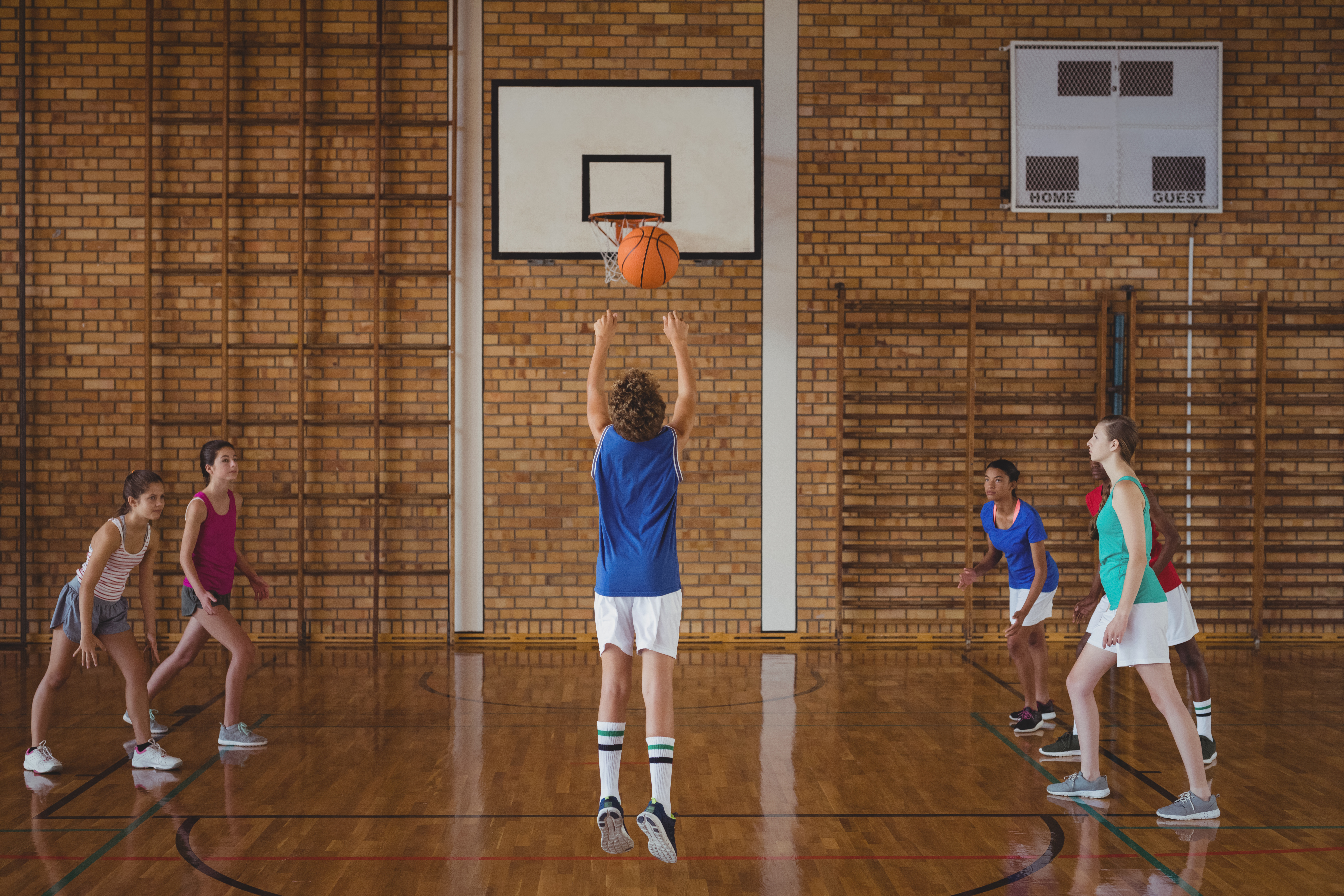 Determined high school kids playing basketball