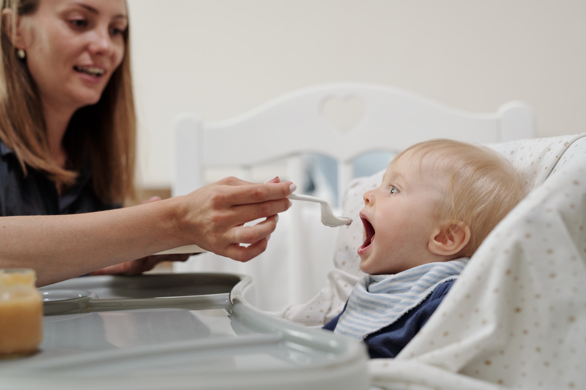 Giving Spoon Of Baby Food