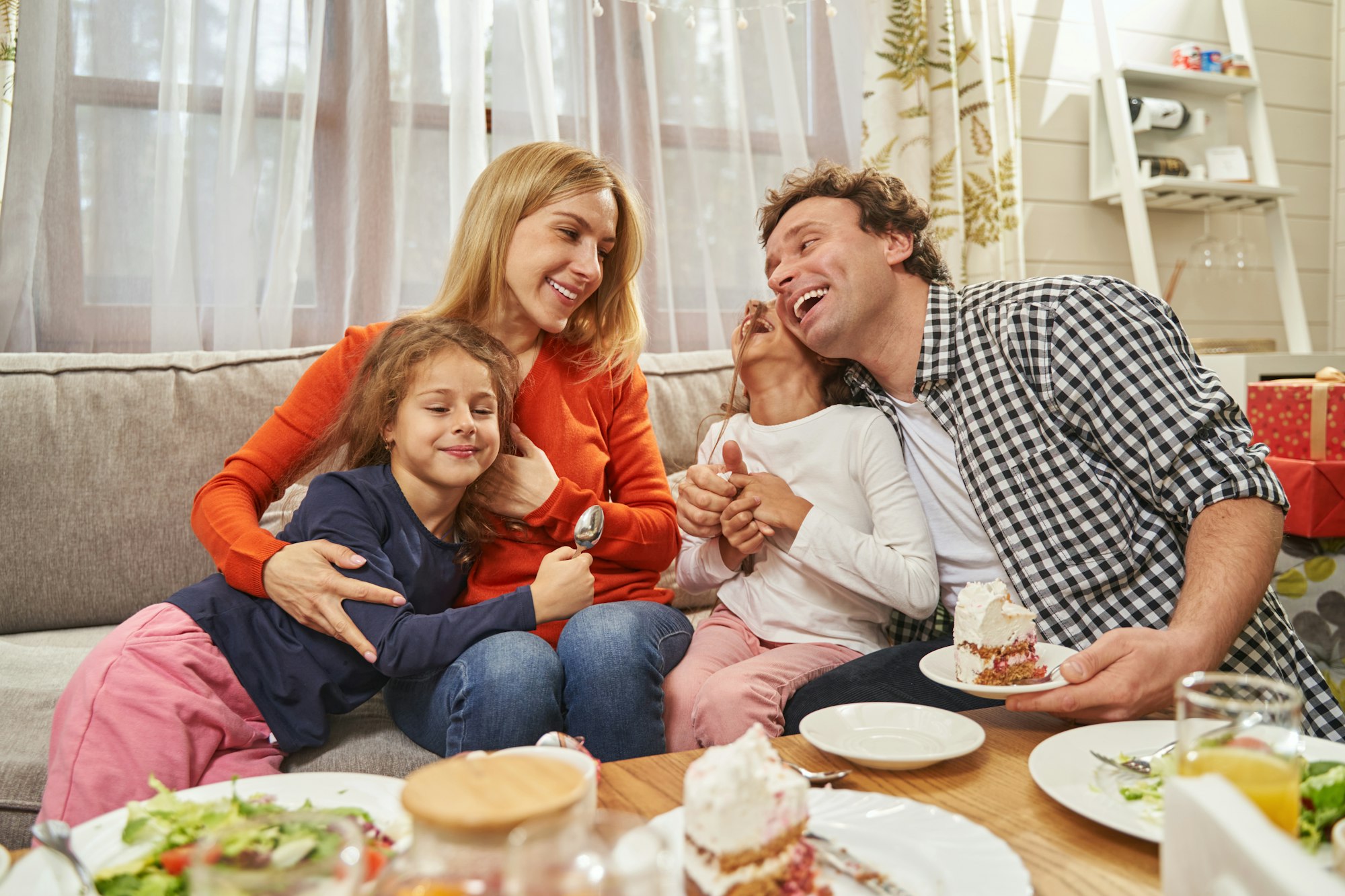 Portrait of loving parents sitting with daughters