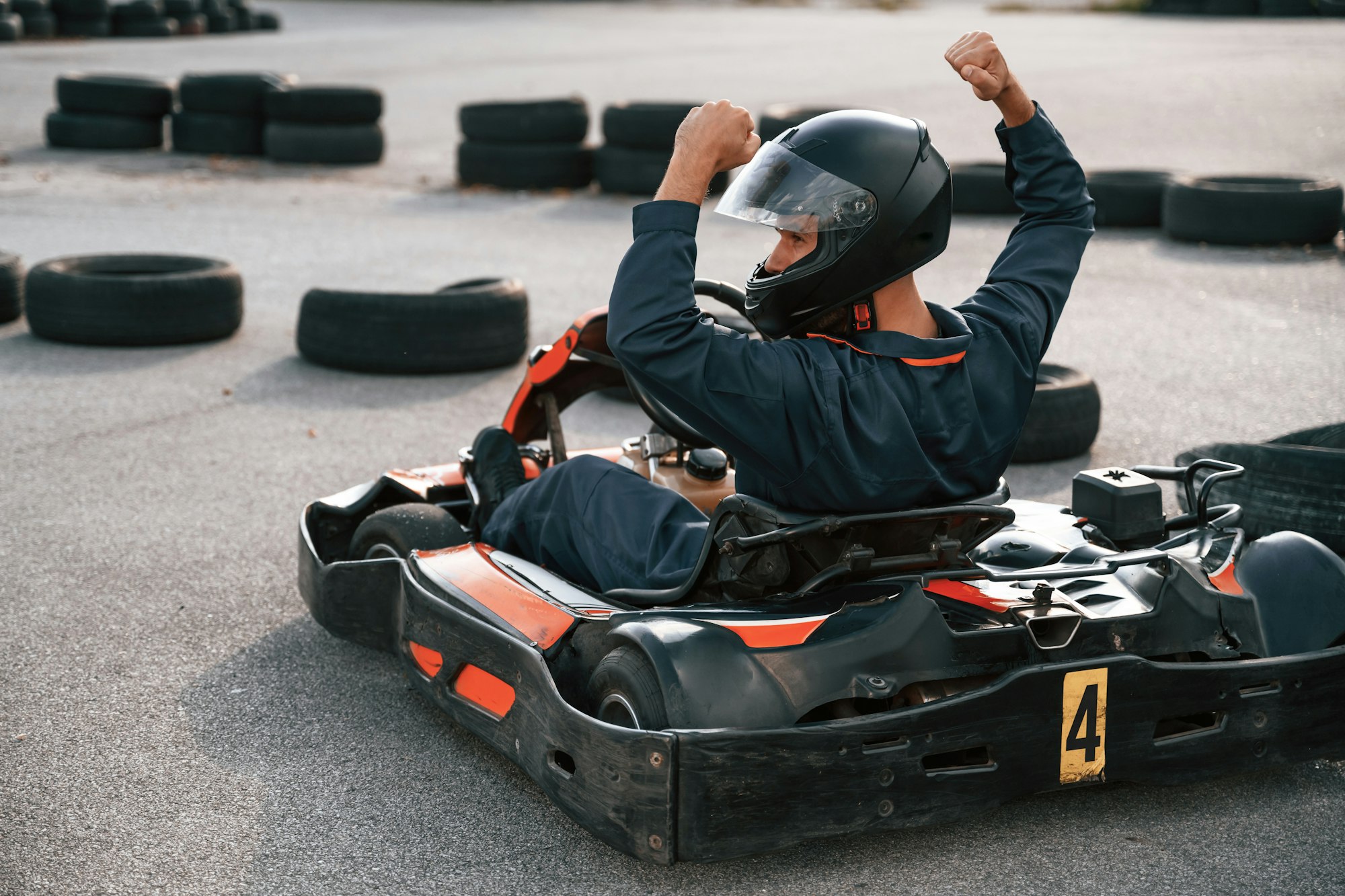 Celebrating victory. Man is outdoors, kart racing conception
