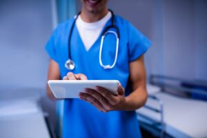 Doctor using digital tablet in ward at hospital